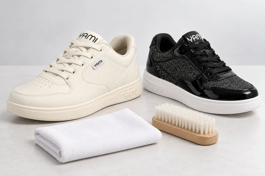 Yami SpinSole 01 G2 Cream and Black Patent dance sneakers beside a soft cloth and nylon cleaning brush.
